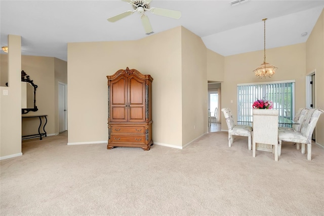 dining space featuring ceiling fan with notable chandelier, lofted ceiling, and light carpet