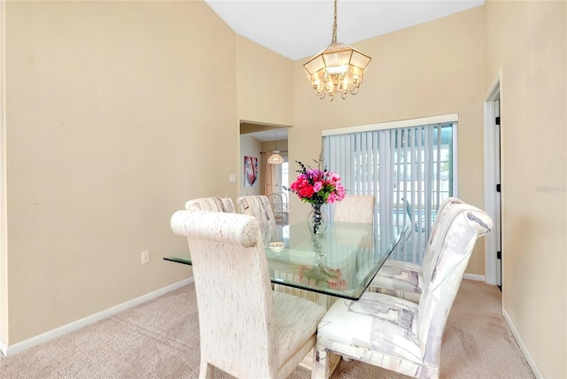 carpeted dining space featuring a towering ceiling and a notable chandelier