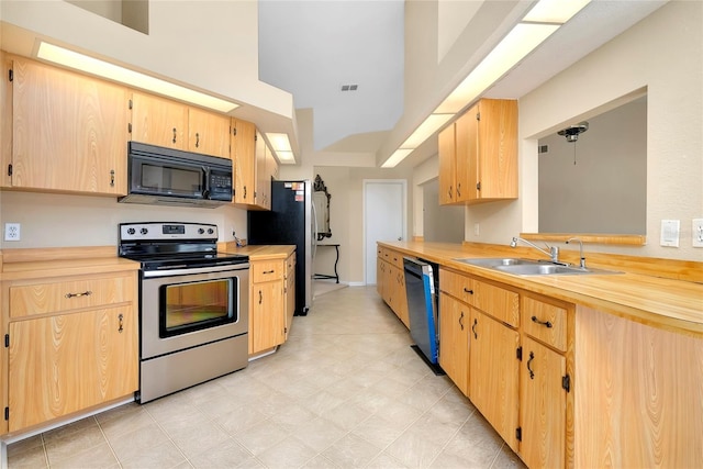 kitchen featuring black appliances, light brown cabinets, and sink