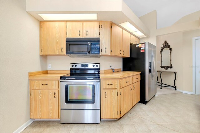 kitchen featuring light brown cabinetry and appliances with stainless steel finishes