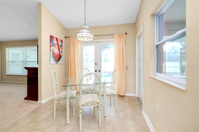 carpeted dining space with french doors