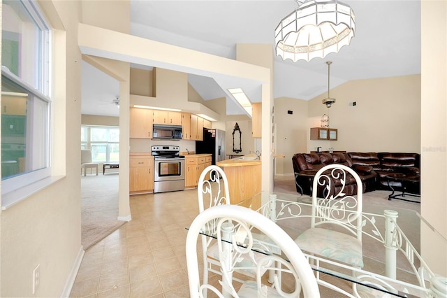 dining area with ceiling fan and vaulted ceiling