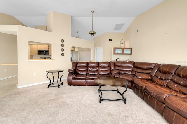 living room with carpet flooring and vaulted ceiling