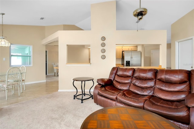 tiled living room featuring vaulted ceiling and ceiling fan