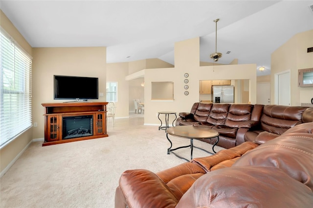 living room featuring carpet flooring, ceiling fan, and lofted ceiling