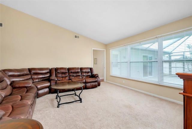 carpeted living room featuring vaulted ceiling