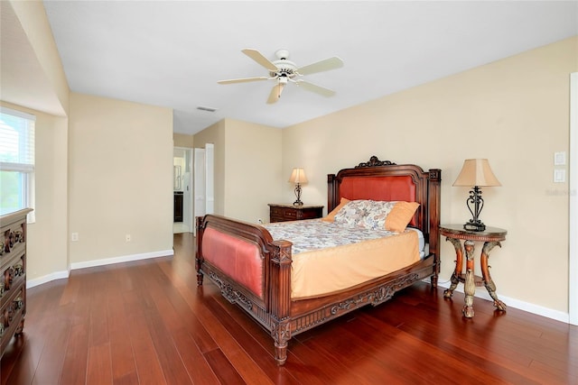 bedroom with dark hardwood / wood-style flooring and ceiling fan