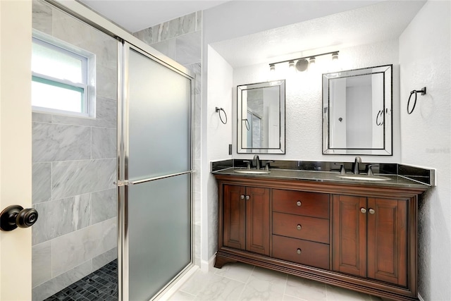 bathroom featuring vanity and an enclosed shower