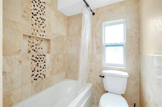 bathroom featuring shower / tub combo and toilet