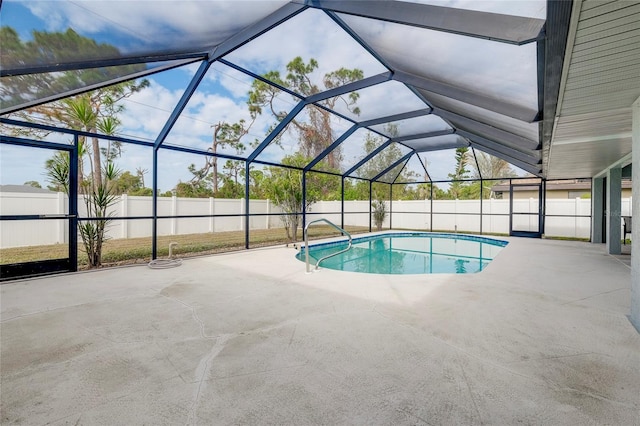 view of swimming pool featuring a lanai and a patio area