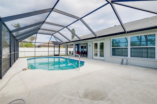 view of pool featuring glass enclosure, french doors, and a patio