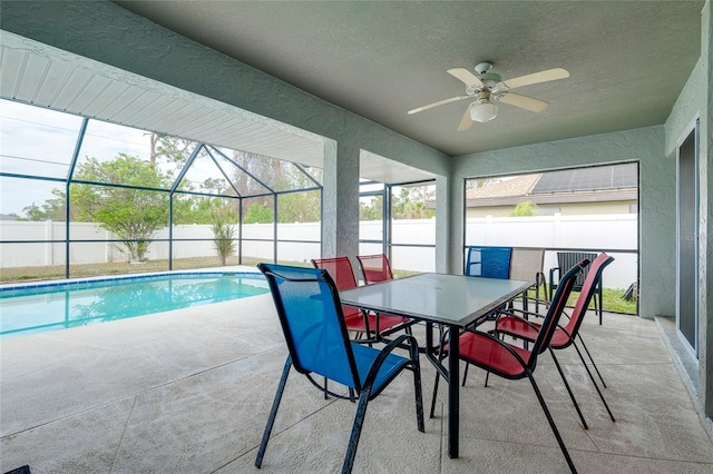 view of pool with a lanai, ceiling fan, and a patio area