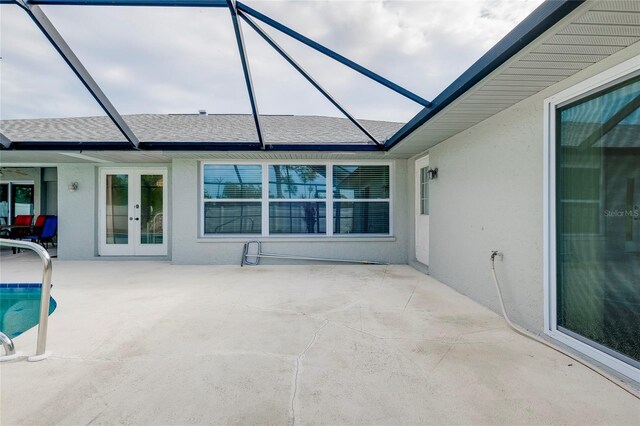 view of patio / terrace with french doors and glass enclosure