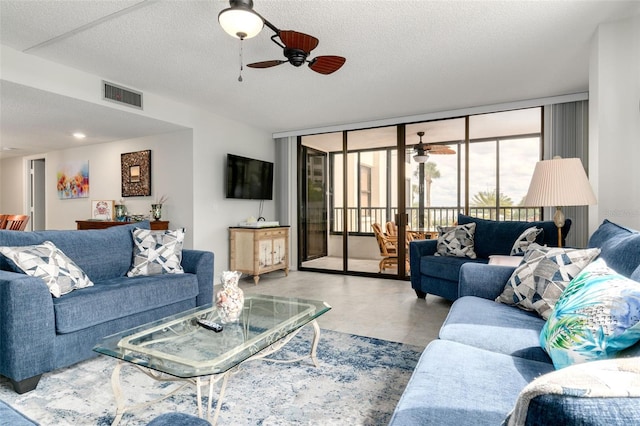 living room with expansive windows and a textured ceiling