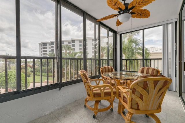 sunroom with plenty of natural light and ceiling fan