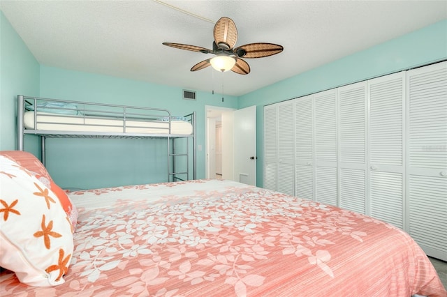 bedroom with a textured ceiling, a closet, and ceiling fan