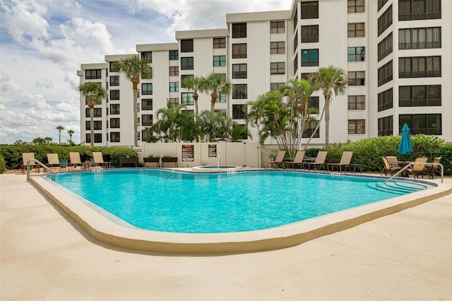 view of pool with a patio area and a community hot tub