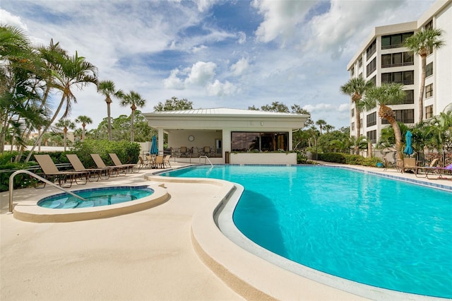 view of pool featuring a patio area and a hot tub