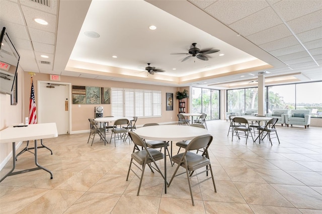 dining area featuring a tray ceiling and ceiling fan