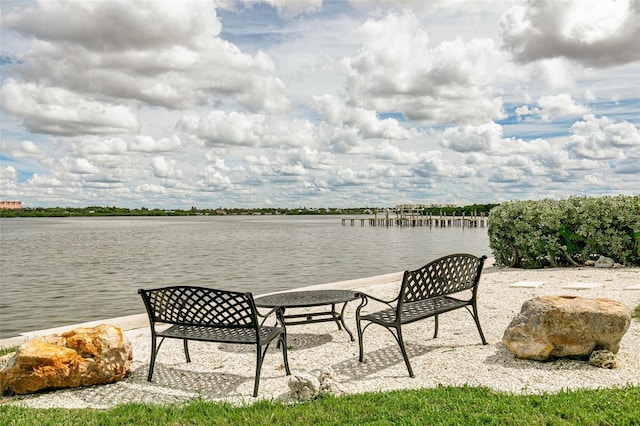 view of patio featuring a water view and a boat dock