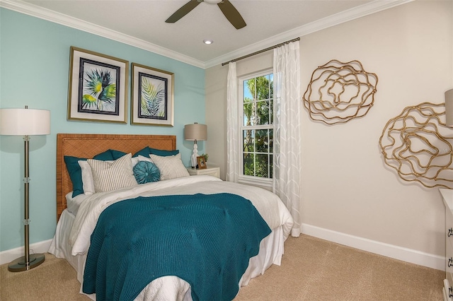 carpeted bedroom with ceiling fan and crown molding