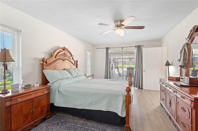 bedroom featuring access to outside, ceiling fan, and light hardwood / wood-style flooring