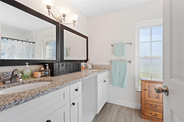 bathroom with wood-type flooring, vanity, a shower with curtain, and plenty of natural light