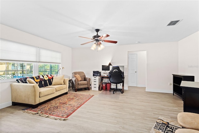 living room with ceiling fan and light wood-type flooring