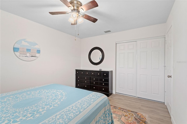 bedroom featuring ceiling fan, light hardwood / wood-style floors, and a closet