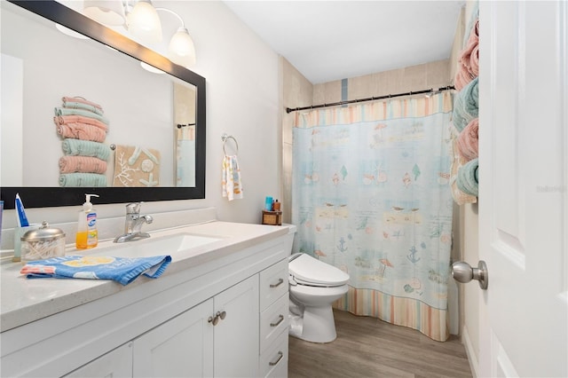 bathroom with a shower with curtain, hardwood / wood-style floors, vanity, and toilet