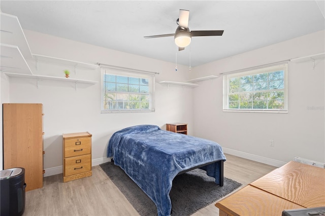 bedroom with light hardwood / wood-style flooring and ceiling fan