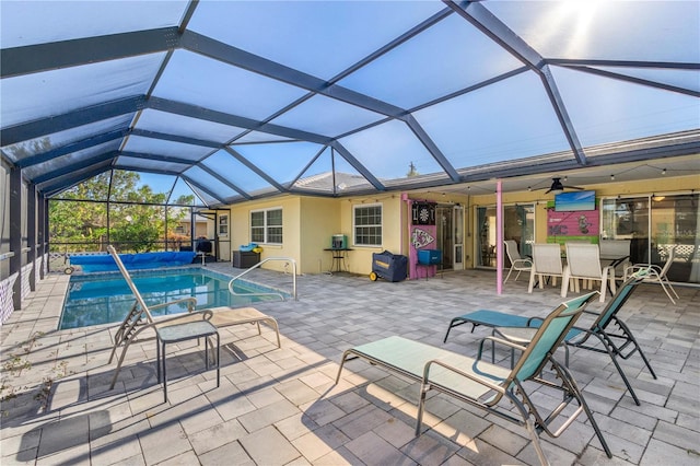 view of swimming pool featuring a lanai, ceiling fan, and a patio