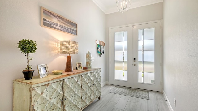 doorway with french doors, crown molding, and a notable chandelier