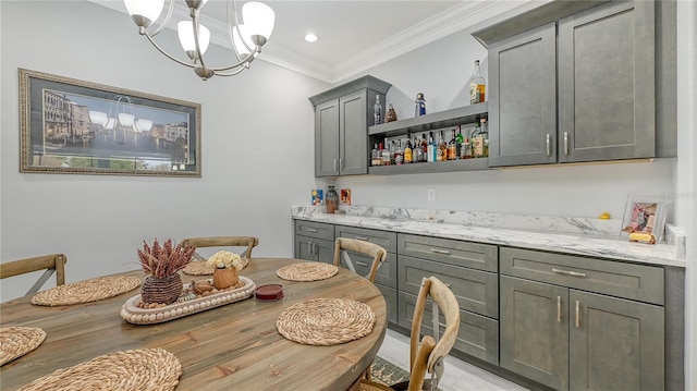 dining space featuring a chandelier and ornamental molding