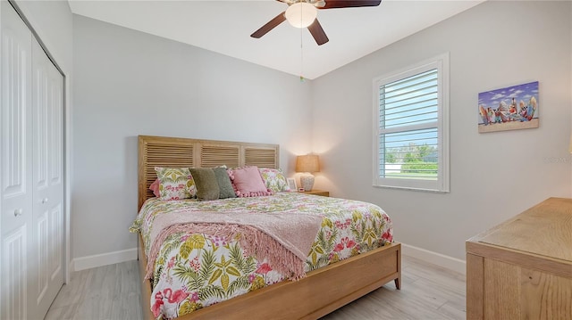 bedroom with light hardwood / wood-style floors, a closet, and ceiling fan