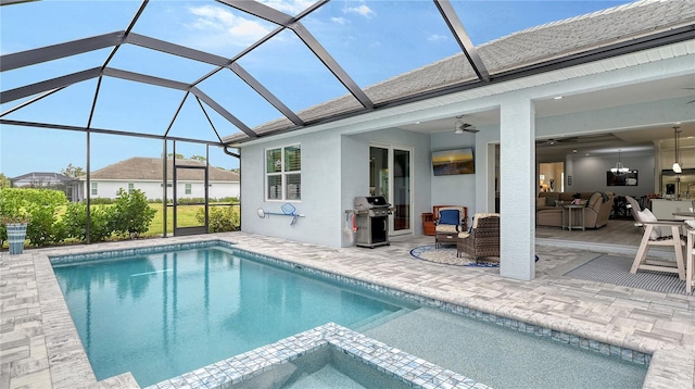 view of pool with outdoor lounge area, glass enclosure, ceiling fan, area for grilling, and a patio area