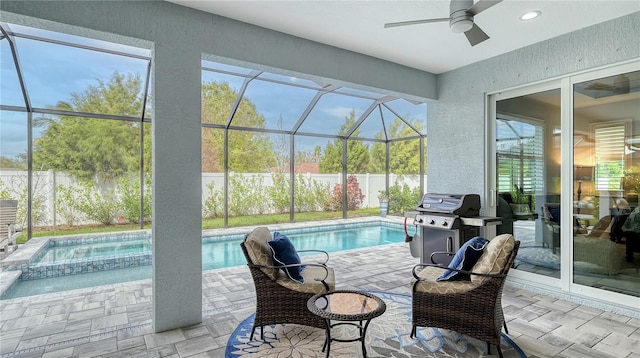 view of swimming pool with a lanai, a patio area, an in ground hot tub, and ceiling fan