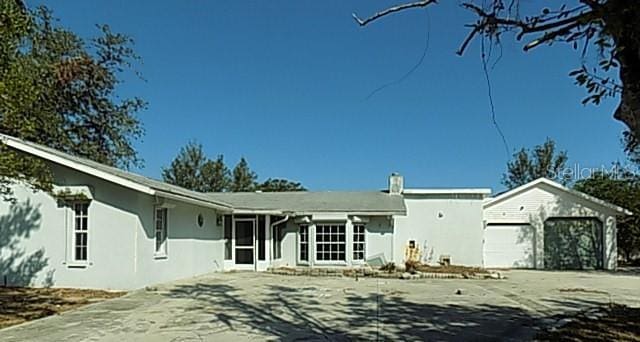 rear view of property featuring a garage