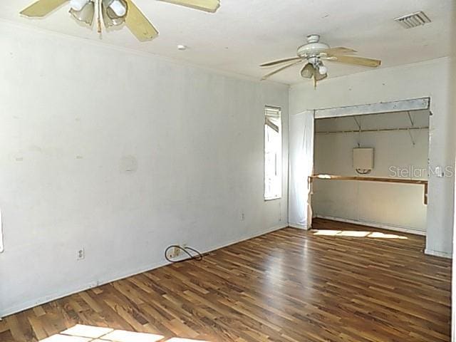 unfurnished bedroom featuring ceiling fan, dark wood-type flooring, and a closet