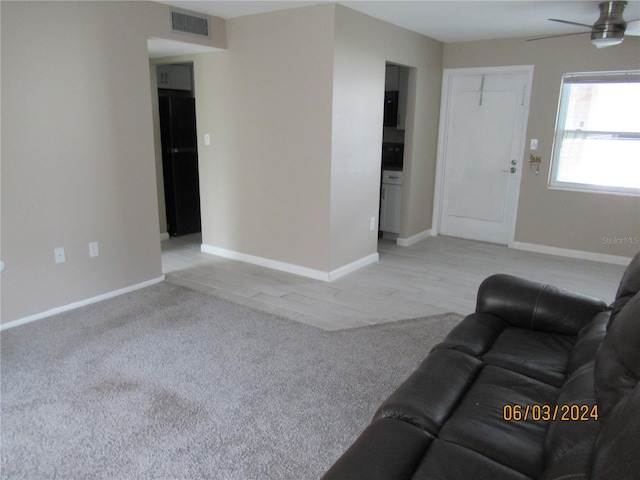 living room with ceiling fan and light carpet