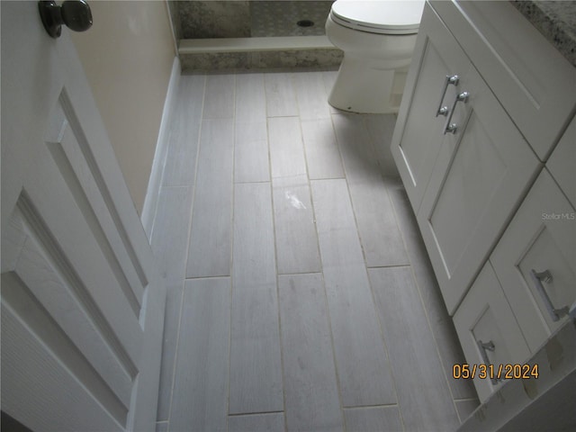 bathroom with walk in shower and toilet