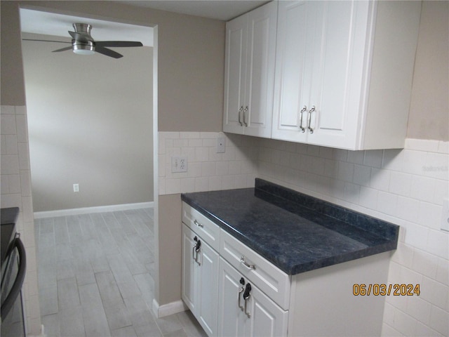 kitchen with white cabinets, ceiling fan, and backsplash