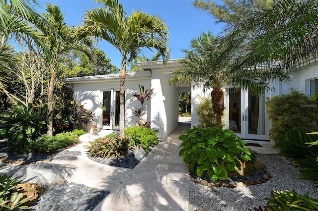 entrance to property with french doors and stucco siding