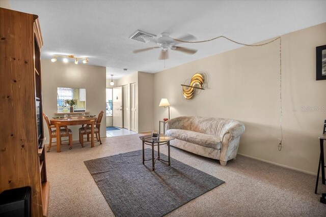 living room featuring light colored carpet and ceiling fan