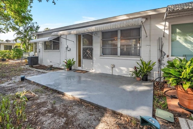 doorway to property featuring a patio and central AC