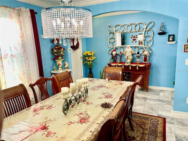 dining room with ornamental molding and an inviting chandelier