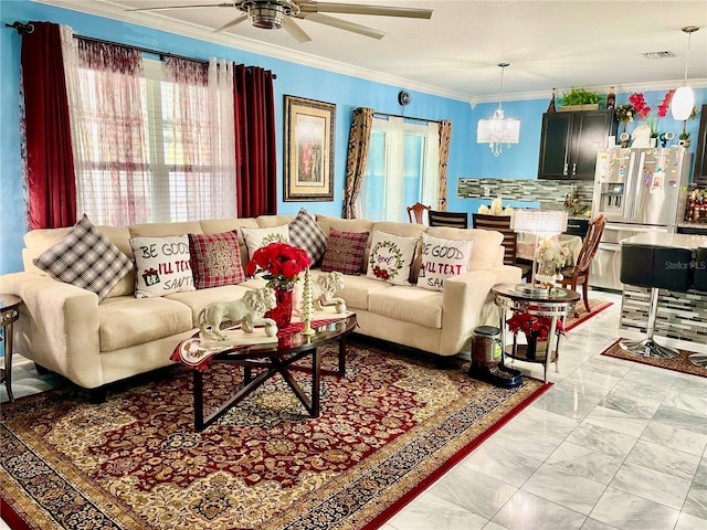 living room with ceiling fan with notable chandelier and crown molding