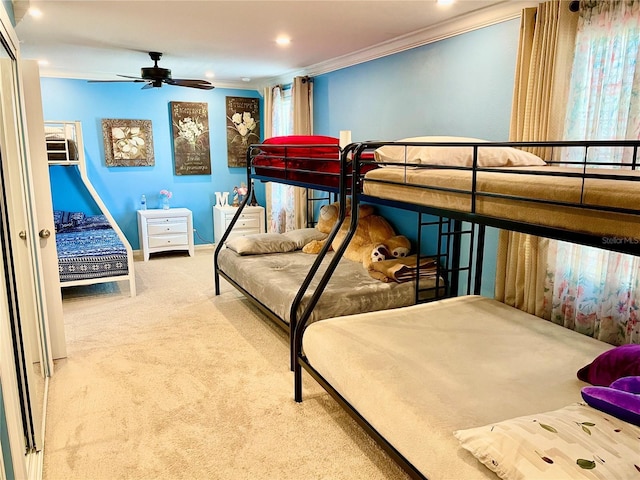 carpeted bedroom featuring ceiling fan and ornamental molding