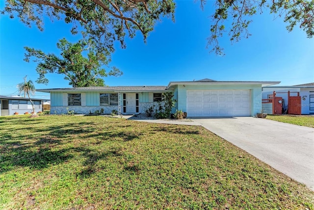 ranch-style house featuring a garage and a front lawn