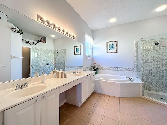 bathroom featuring vanity, shower with separate bathtub, a textured ceiling, and tile patterned floors